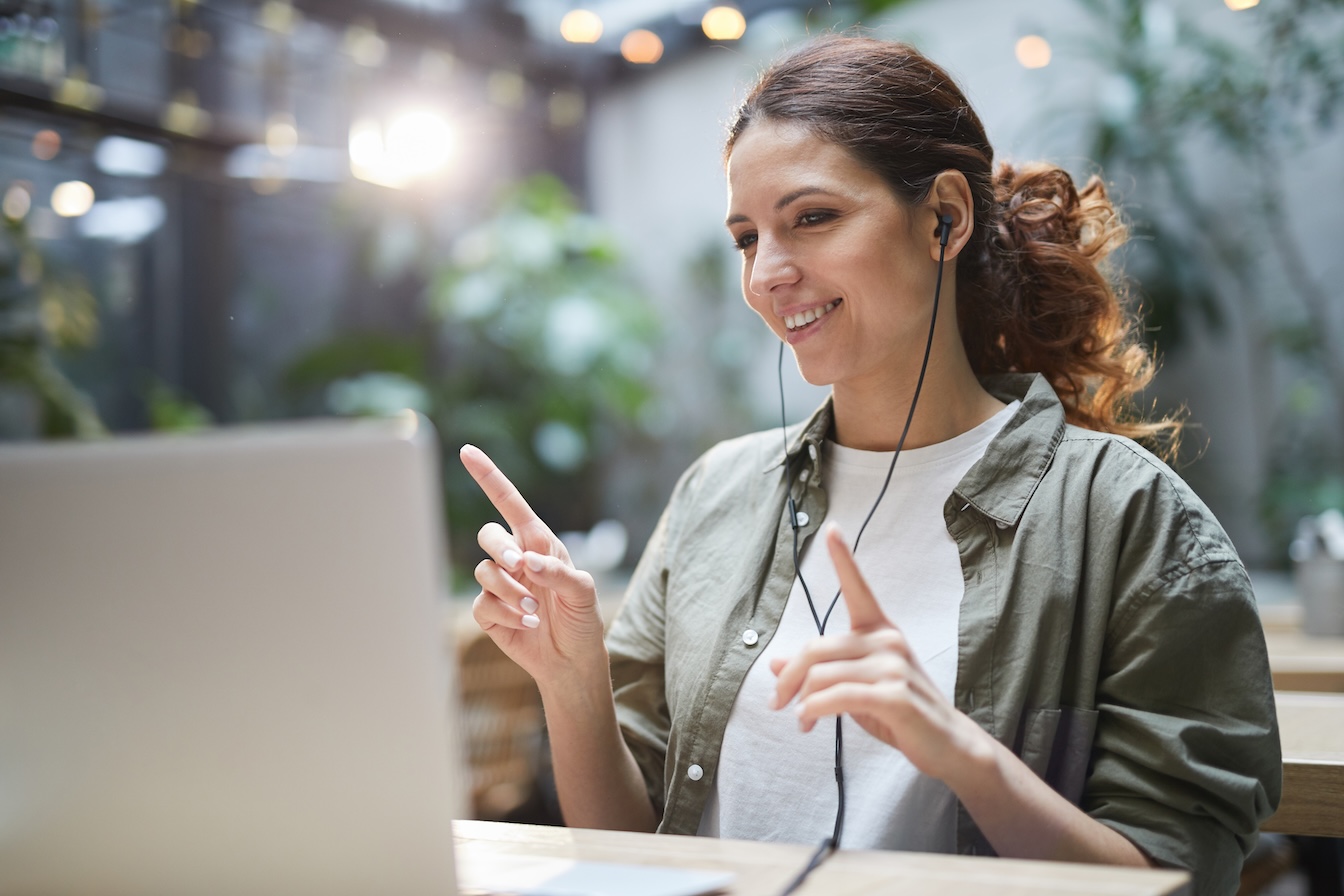 Contemporary Woman Listening to Music in Outdoor Cafe
